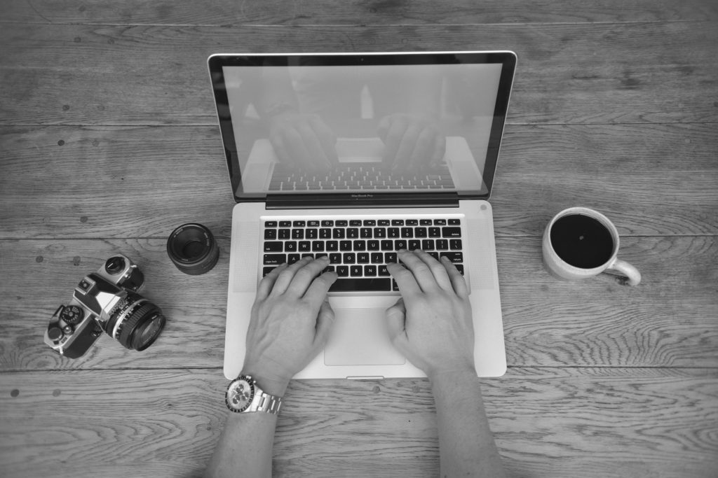 ghostblogger, freelance writer, black and white image of hands on laptop