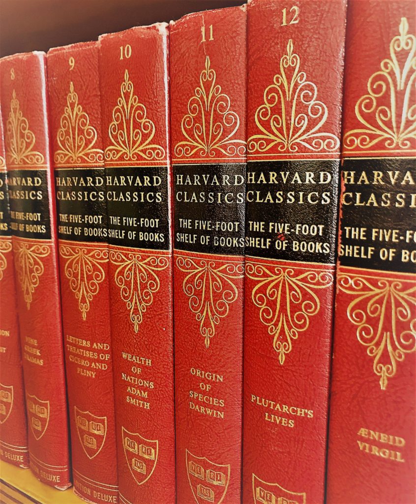 closeup of red Harvard Classics books on shelf