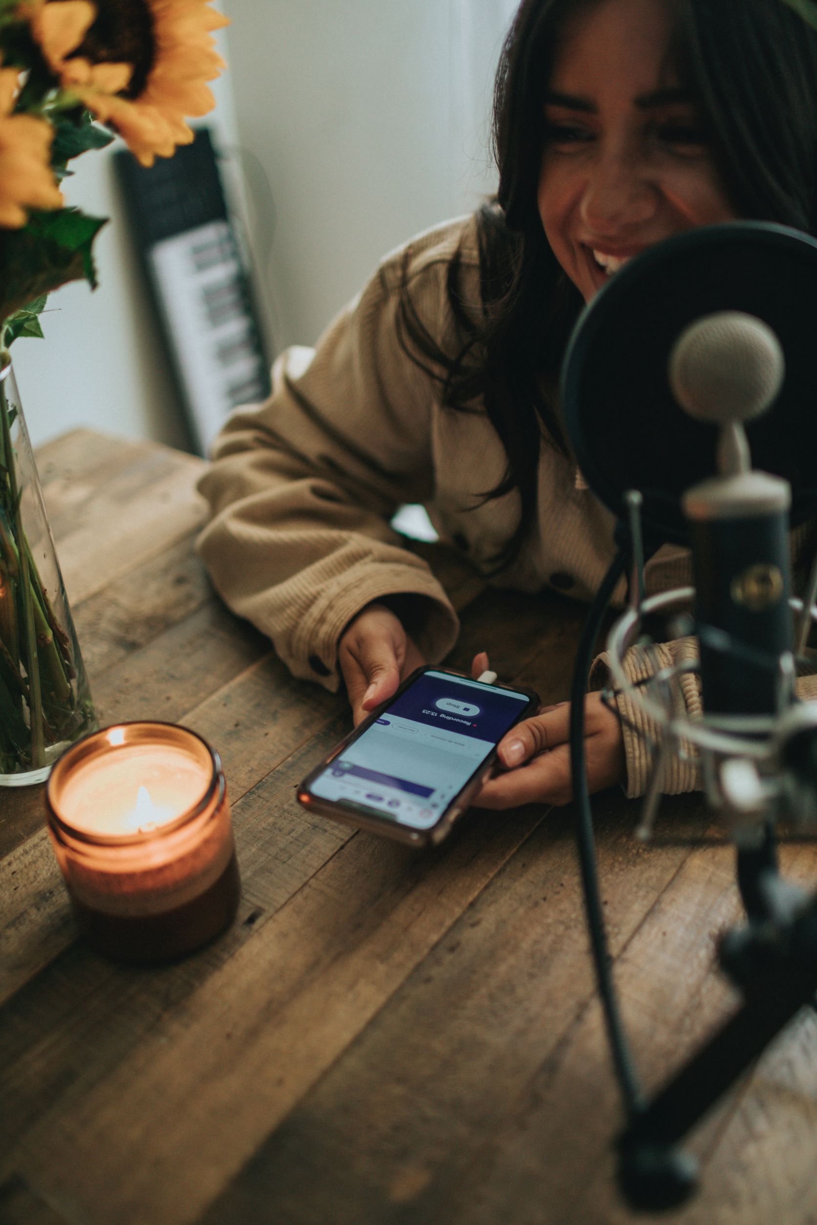 Woman speaking into microphone for blog/podcast